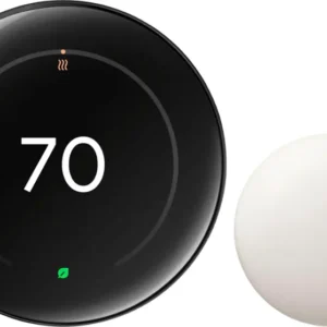 Smart thermostat with a sleek black dial and a white sensor device.