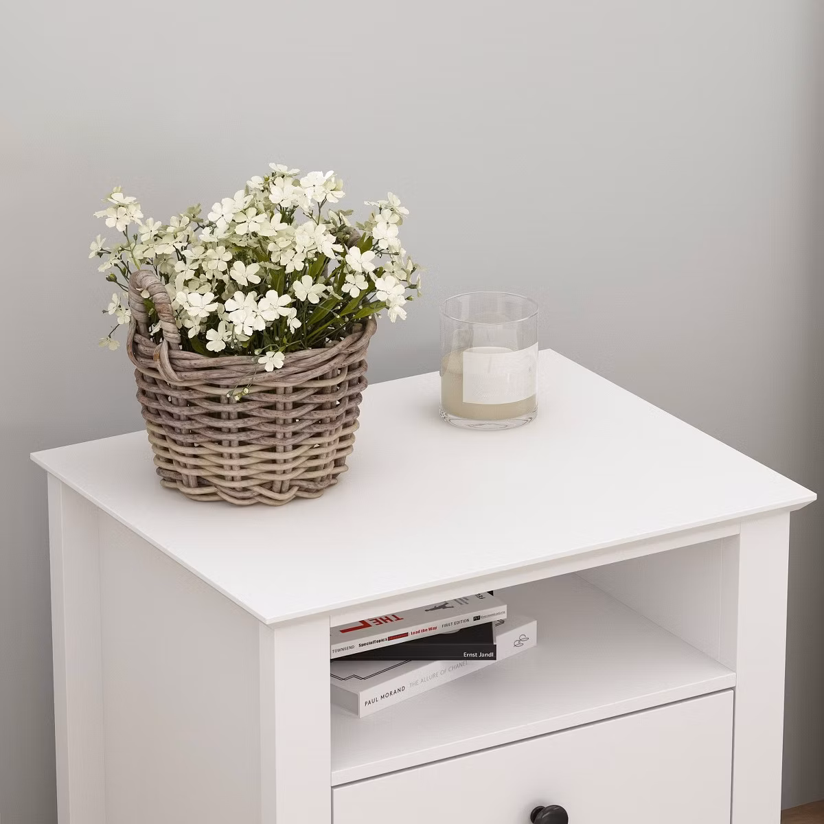 White side table with basket of white flowers